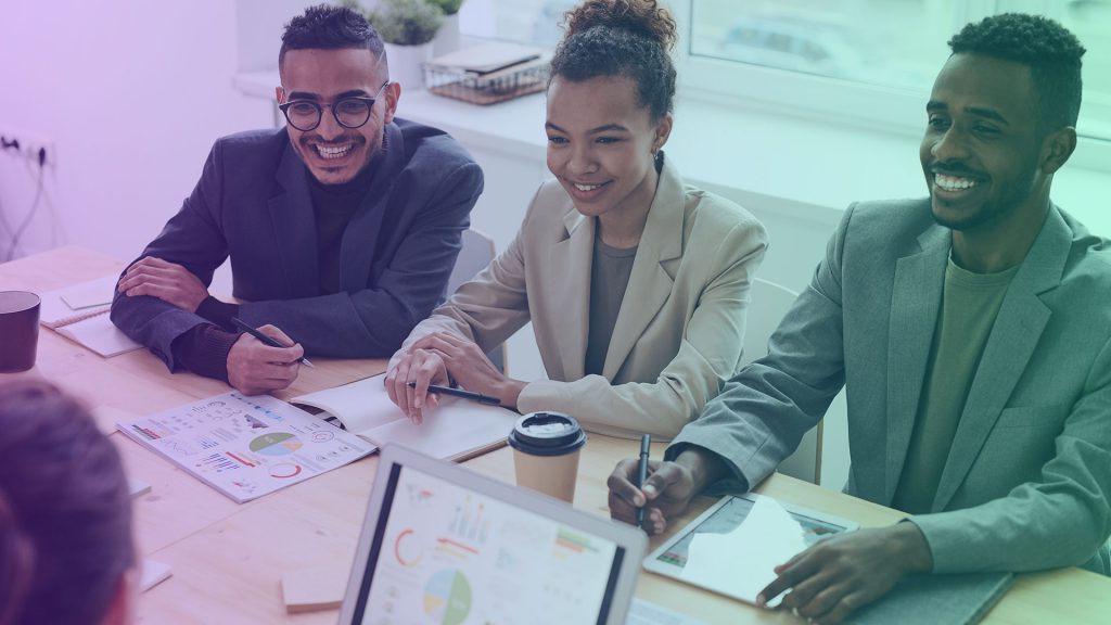 Salespeople smiling in a meeting